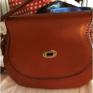 Hand tooled, cowhide leather, shoulder bag.